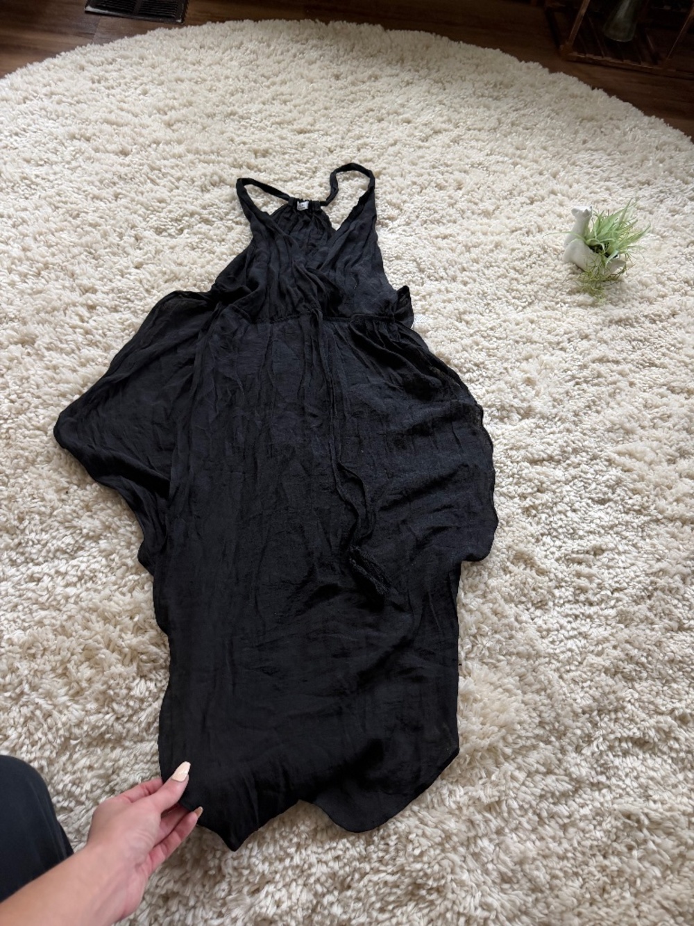 A chic black asymmetrical dress with flowing drape for an elegant silhouette. Li